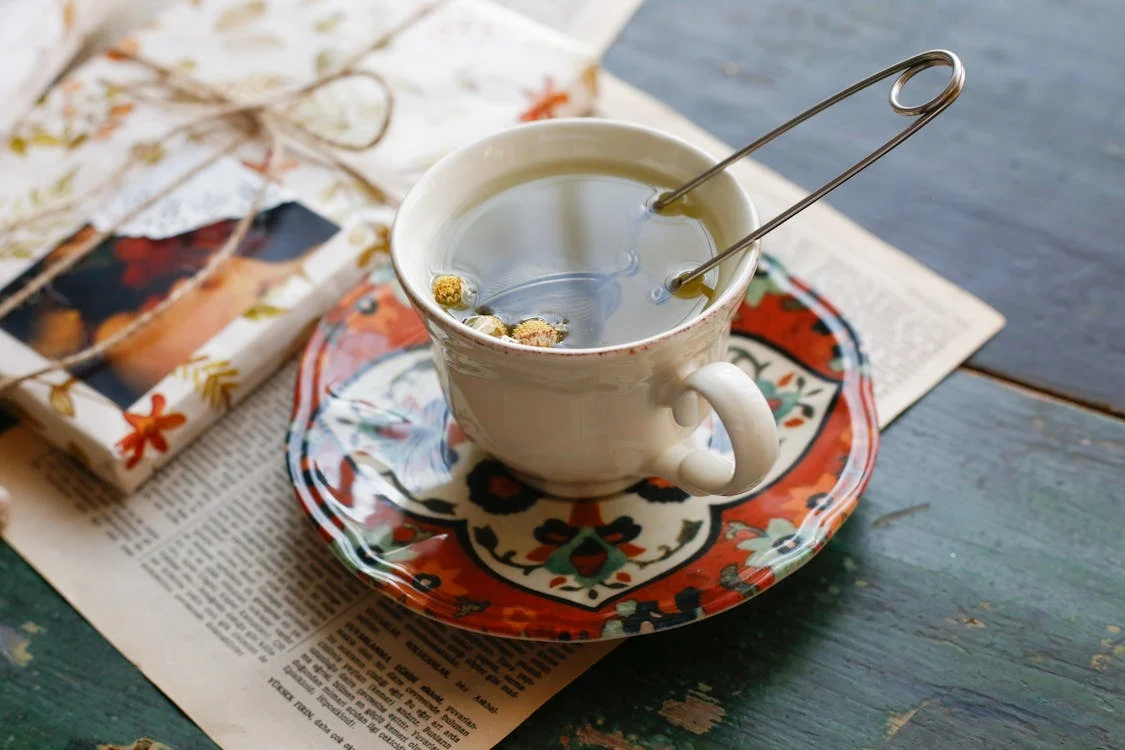 Cup of Chamomile tea with a tea infuser