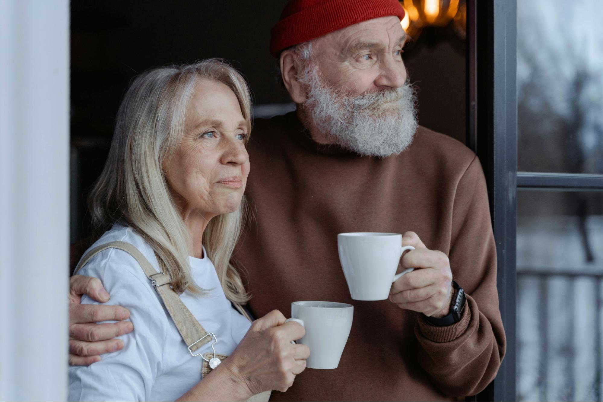 men and women holding white cups.
          