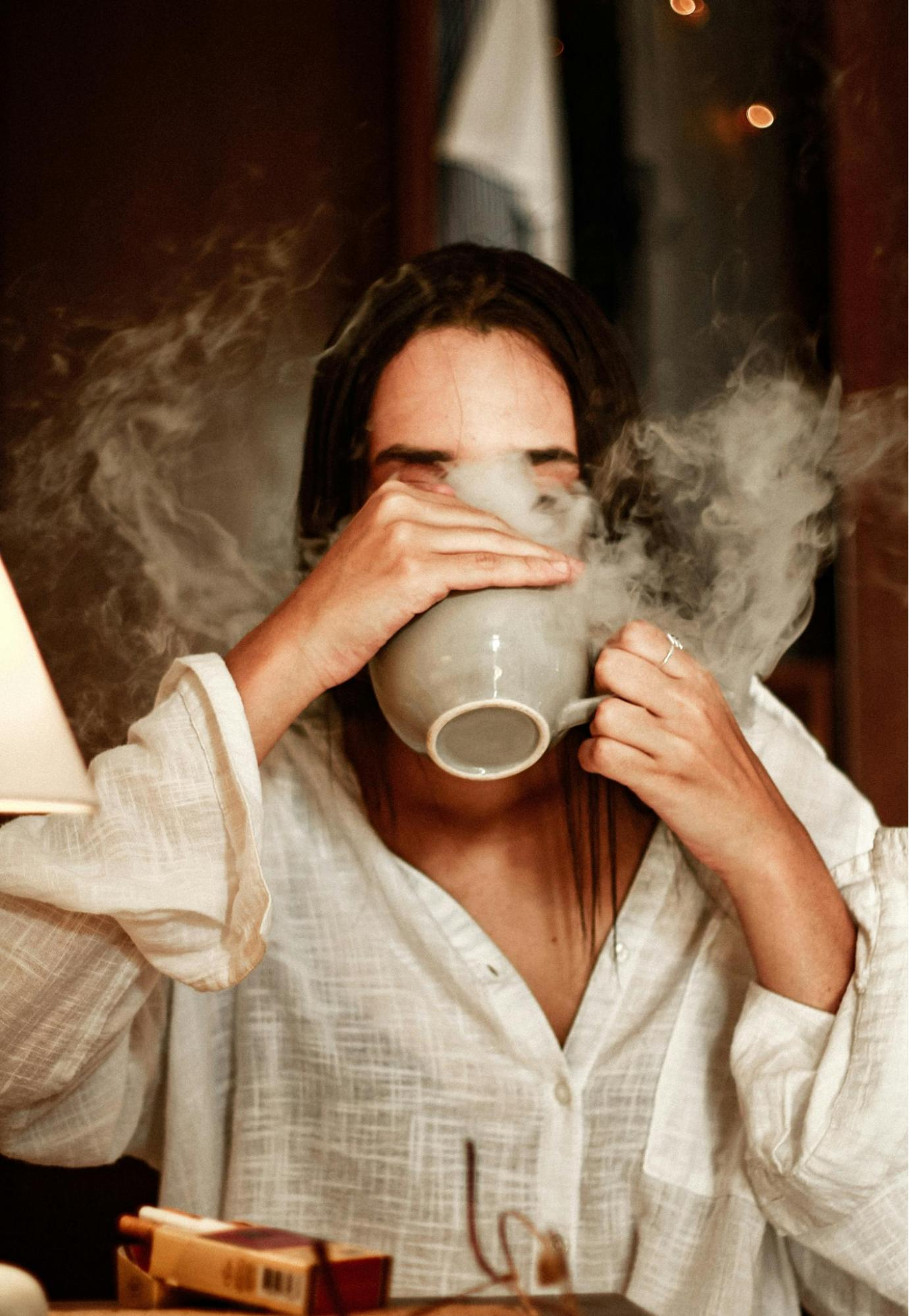women drinking hot tea from cup