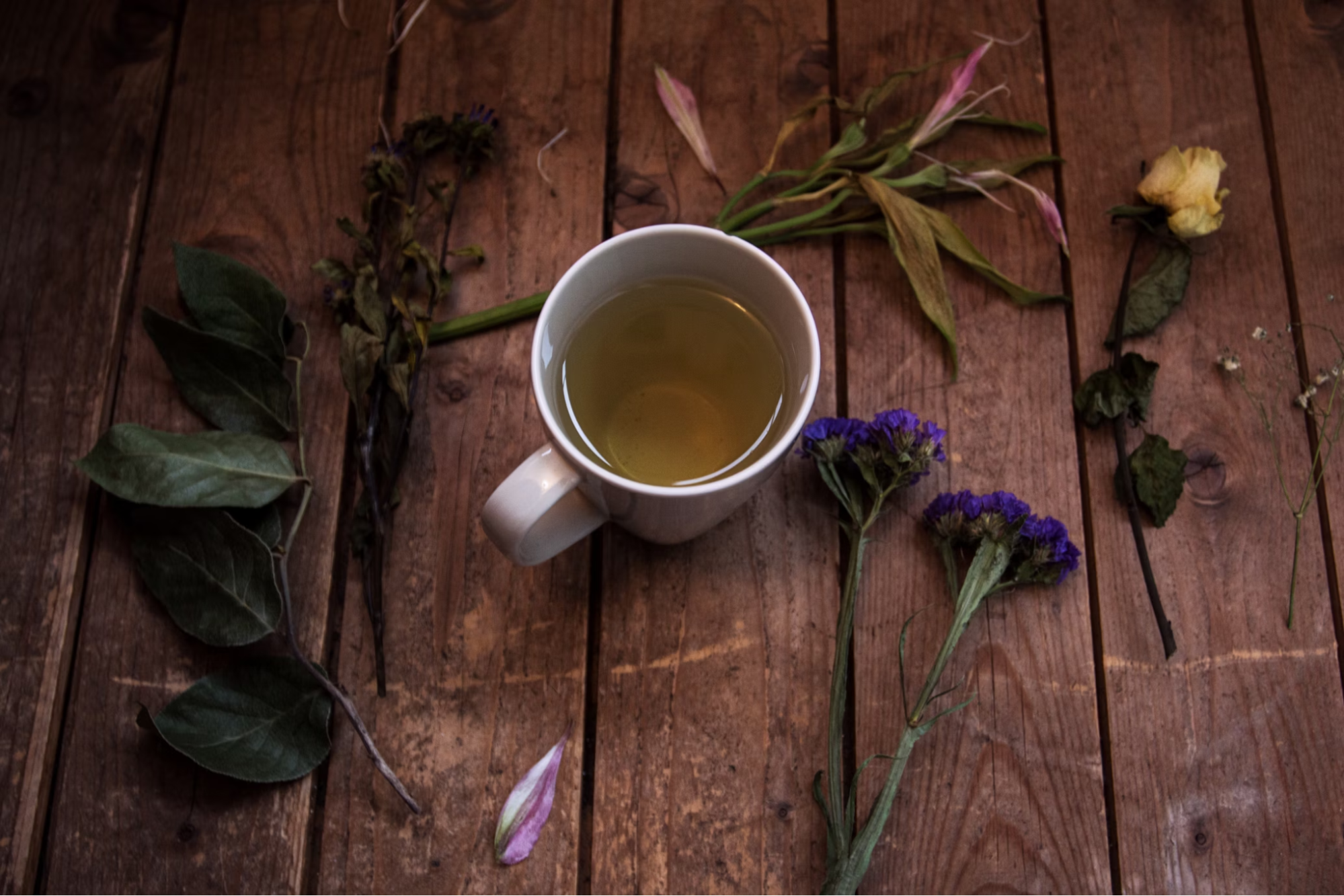 Cup of herbal tea on a rustic wooden table