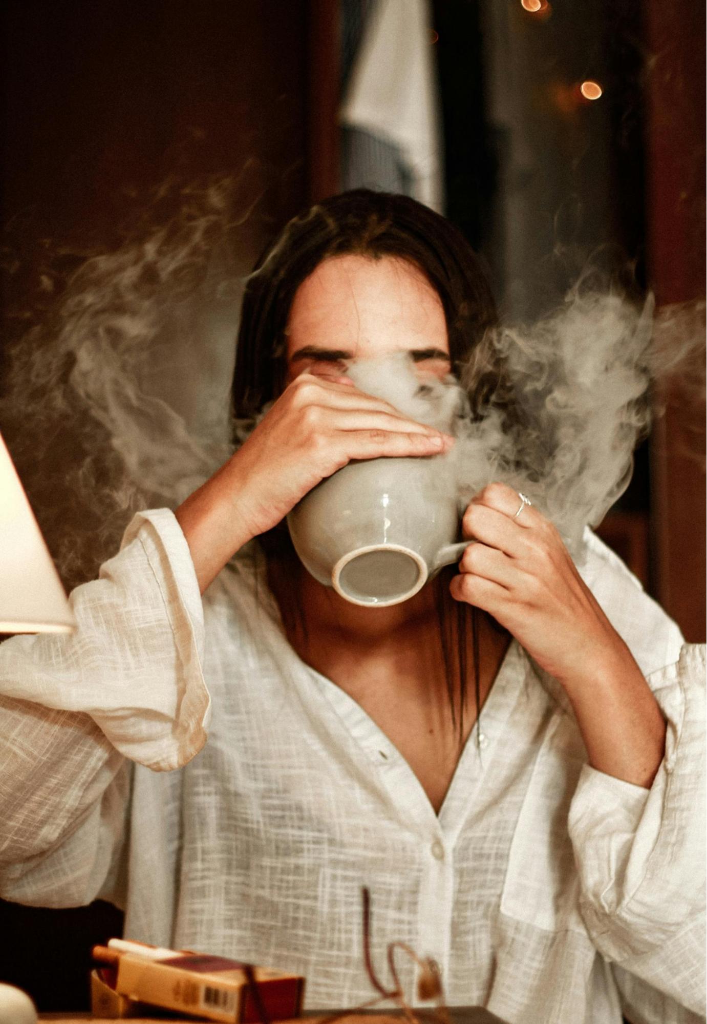 HA women drinking hot tea from cup
        