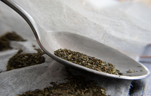 Loose tea leaves on a metal spoon 