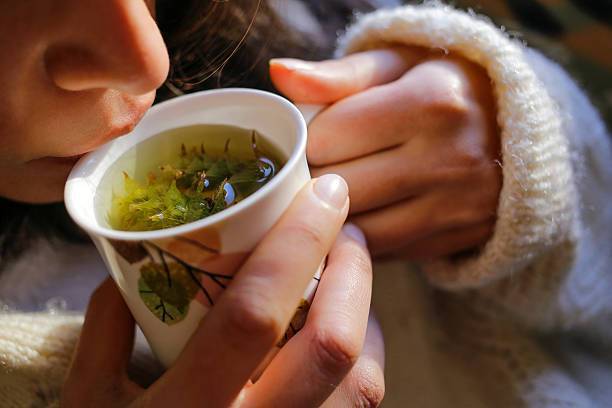 Woman sipping tea from a cup