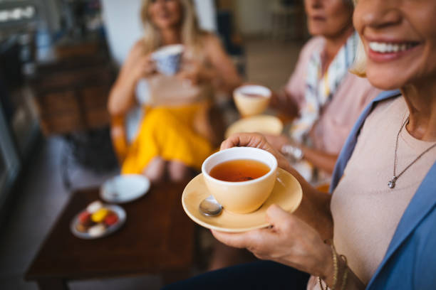 Rosemary tea being poured from a glass teapot into a cup