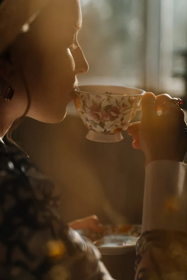A woman sipping tea from a cup